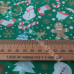 Christmas Snowmen, trees, candy canes on Green Polycotton Print